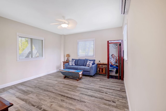 living area with ceiling fan, plenty of natural light, and light hardwood / wood-style floors