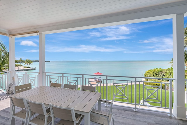 exterior space featuring a balcony and a water view