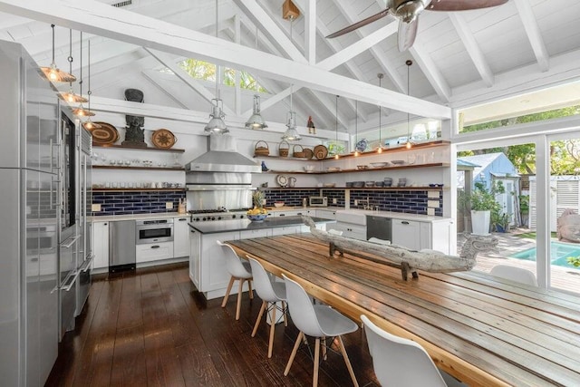 interior space with wall chimney range hood, tasteful backsplash, open shelves, and white cabinetry