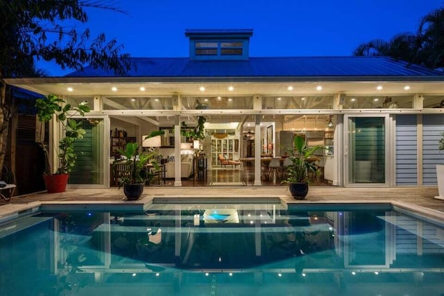 view of swimming pool with an outdoor living space, a lawn, a wooden deck, and a fenced in pool
