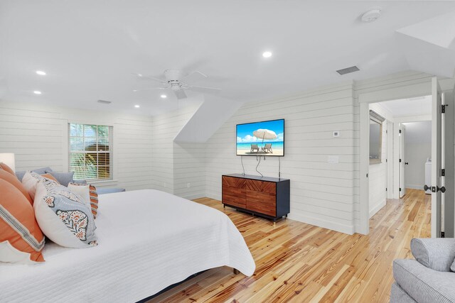 bedroom featuring wooden walls, wood finished floors, ceiling fan, and recessed lighting