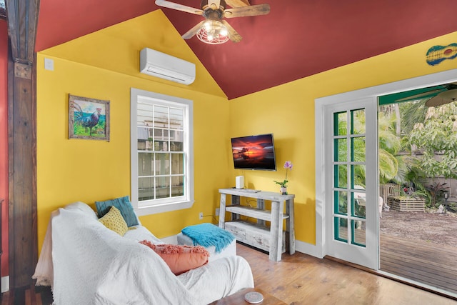 living area featuring ceiling fan, vaulted ceiling, an AC wall unit, and wood finished floors