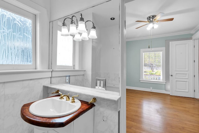 bathroom with vanity, hardwood / wood-style floors, crown molding, and ceiling fan