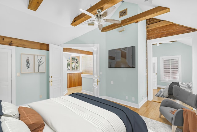 bedroom featuring ensuite bath, light hardwood / wood-style flooring, lofted ceiling with beams, and ceiling fan