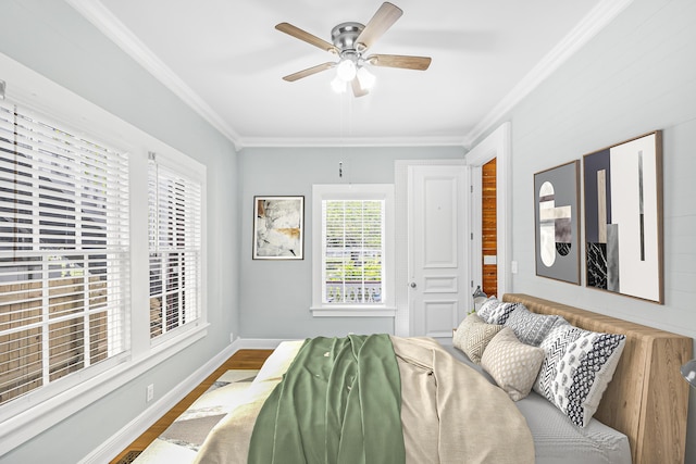 bedroom featuring hardwood / wood-style flooring, ornamental molding, and ceiling fan