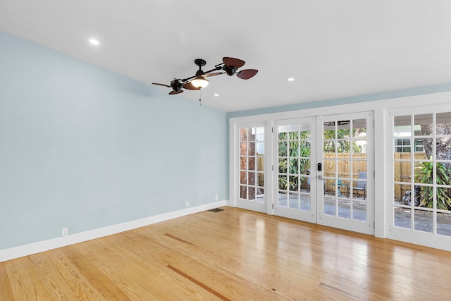 unfurnished room featuring ceiling fan, light hardwood / wood-style floors, and french doors