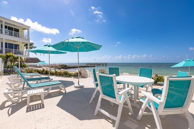 view of patio featuring outdoor dining space and a water view