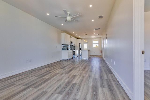 unfurnished living room with ceiling fan, recessed lighting, baseboards, light wood-type flooring, and visible vents