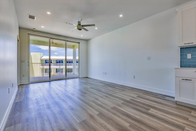 unfurnished living room with ceiling fan, visible vents, baseboards, and light wood-style floors