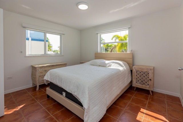 tiled bedroom with multiple windows