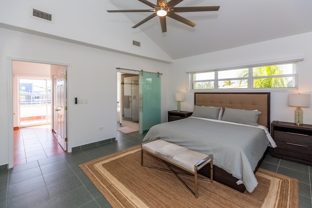 bedroom featuring dark tile patterned floors, ceiling fan, high vaulted ceiling, connected bathroom, and a barn door