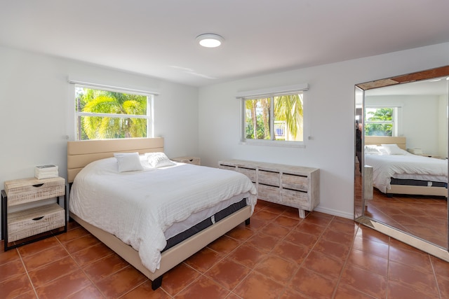 bedroom with dark tile patterned floors