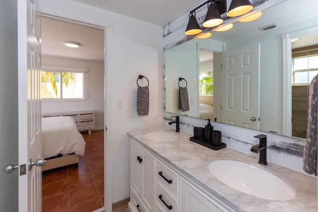 bathroom featuring vanity, tile patterned flooring, and a healthy amount of sunlight