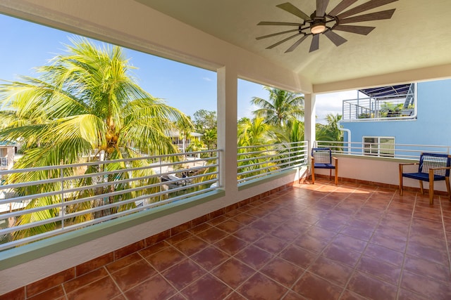 unfurnished sunroom featuring a wealth of natural light and ceiling fan