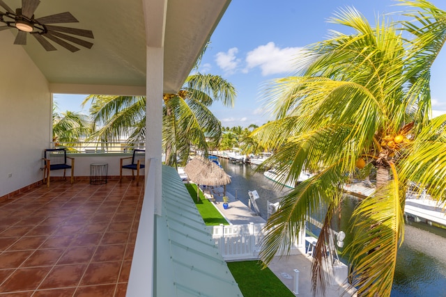 balcony with a water view and ceiling fan