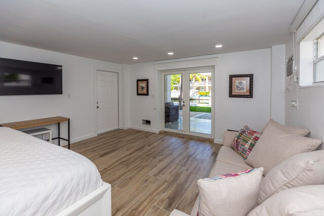 bedroom with access to exterior and light hardwood / wood-style flooring