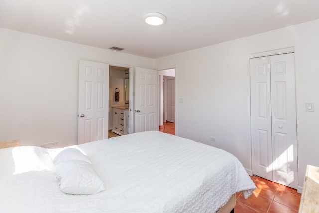 tiled bedroom with a closet