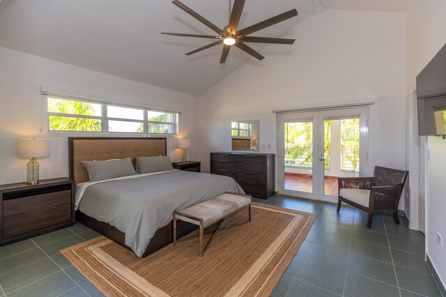 bedroom featuring french doors, access to exterior, high vaulted ceiling, and dark tile patterned floors