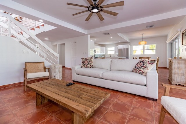 tiled living room with ceiling fan