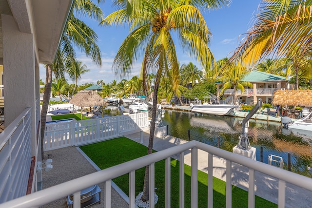 balcony with a boat dock and a water view