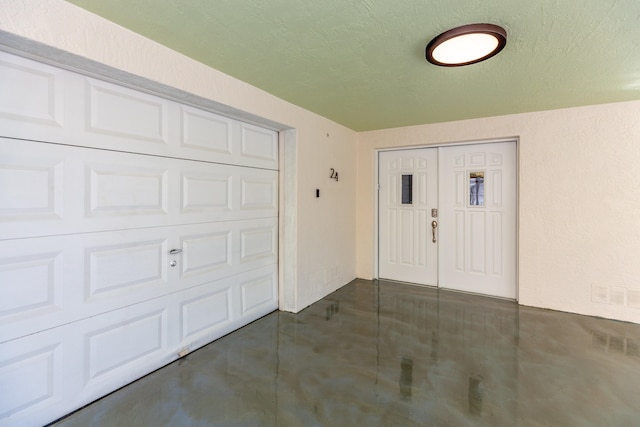 foyer with a textured ceiling