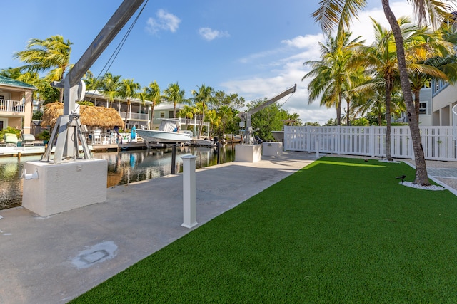 view of yard featuring a water view and a boat dock