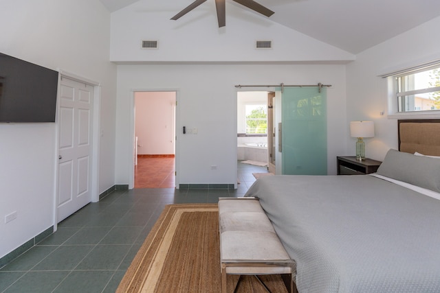 bedroom featuring ensuite bath, ceiling fan, high vaulted ceiling, dark tile patterned flooring, and a barn door