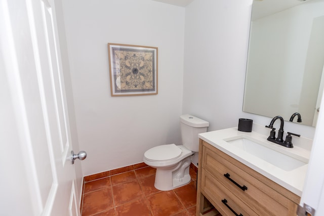 bathroom with vanity, tile patterned flooring, and toilet