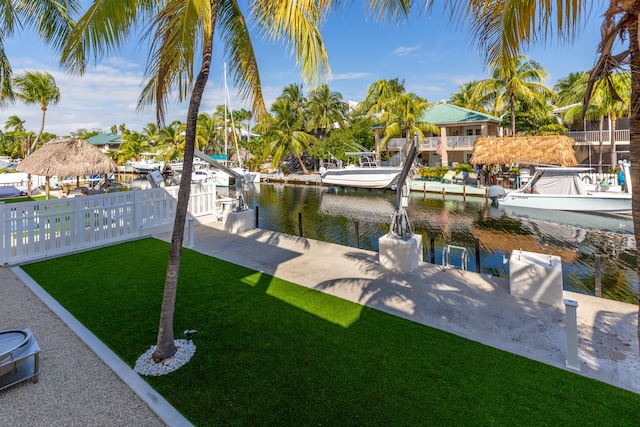 view of dock featuring a water view and a lawn