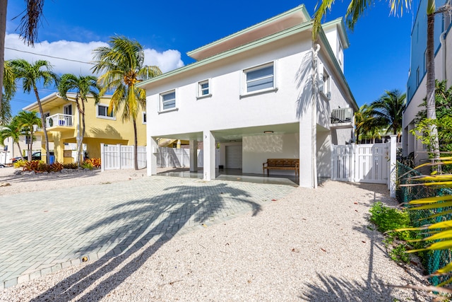 view of front of home with cooling unit, a balcony, and a carport