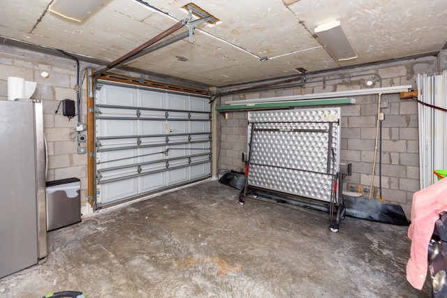 garage with stainless steel fridge