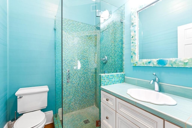 bathroom with vanity, an enclosed shower, and toilet