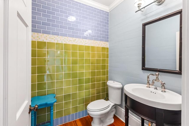 bathroom with ornamental molding, hardwood / wood-style floors, and toilet