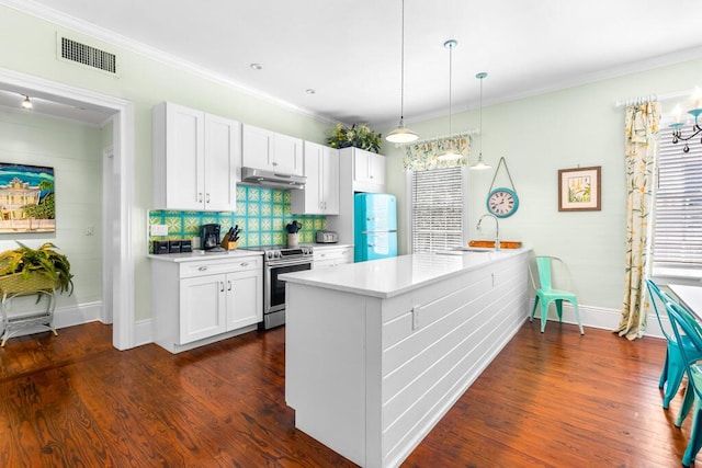 kitchen featuring dark wood-type flooring, hanging light fixtures, white cabinets, stainless steel range oven, and white fridge