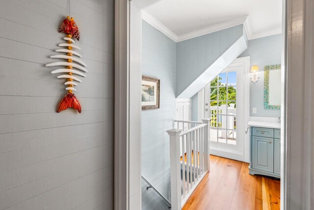 interior space with crown molding and light wood-type flooring