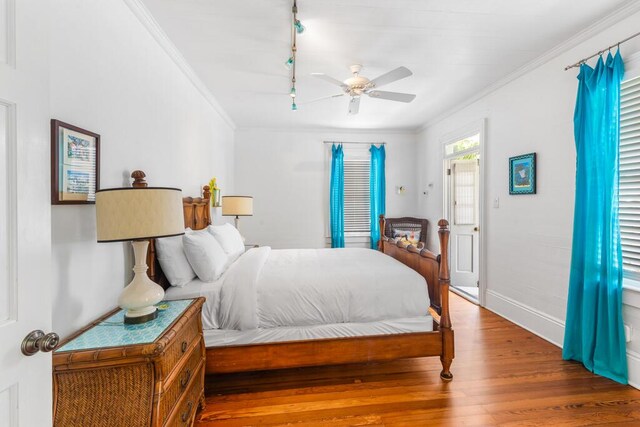 bedroom with crown molding, ceiling fan, and hardwood / wood-style floors