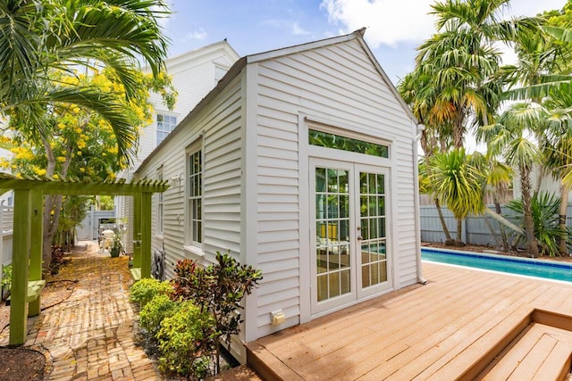 exterior space featuring a fenced in pool and an outdoor structure