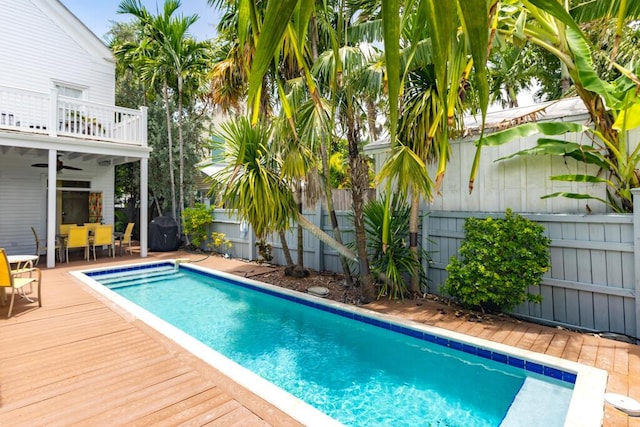 view of swimming pool featuring a wooden deck and ceiling fan