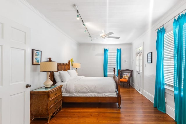 bedroom featuring wood-type flooring, ceiling fan, and crown molding