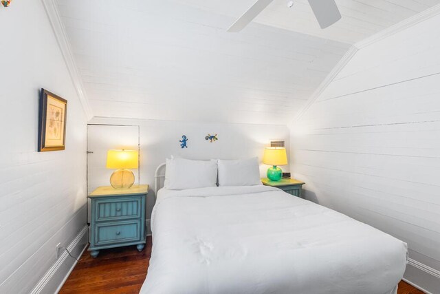 bedroom with crown molding, ceiling fan, lofted ceiling, and dark hardwood / wood-style flooring