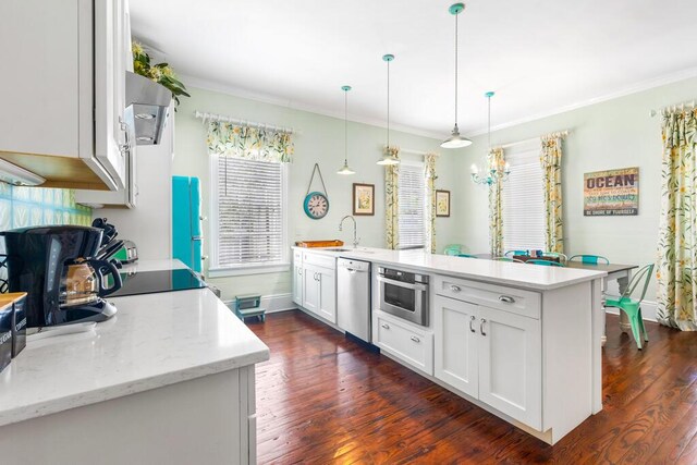 kitchen featuring white cabinetry, dishwasher, hanging light fixtures, and a center island with sink