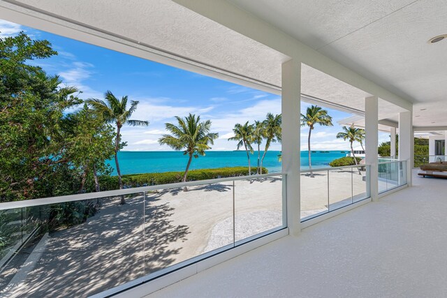 exterior space featuring a balcony and a water view