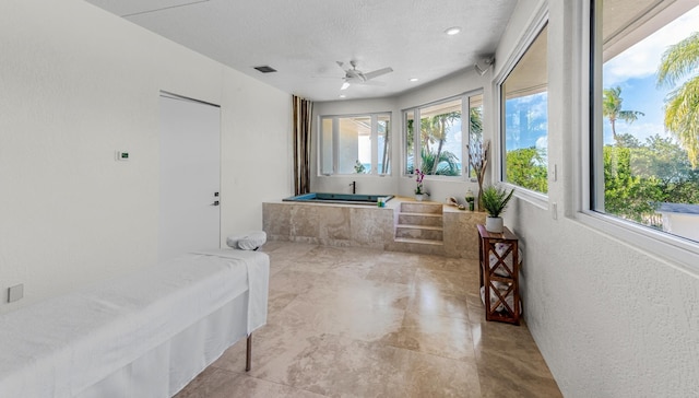 bathroom featuring a bathing tub and a textured ceiling