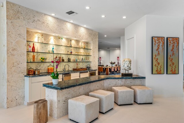 bar featuring white cabinetry