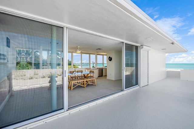 view of patio / terrace with a water view and a balcony