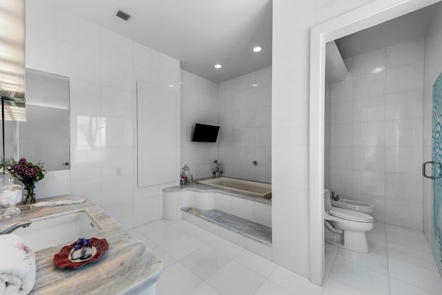 full bathroom featuring toilet, separate shower and tub, tile walls, a bidet, and tile patterned flooring