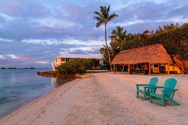 exterior space with a gazebo, a beach view, and a water view