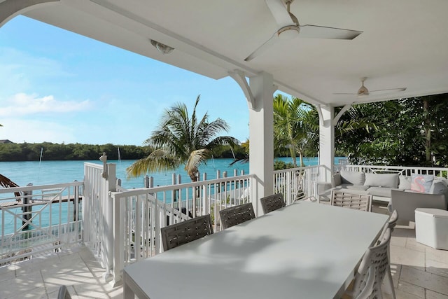 view of patio / terrace featuring a water view, outdoor dining area, ceiling fan, and outdoor lounge area