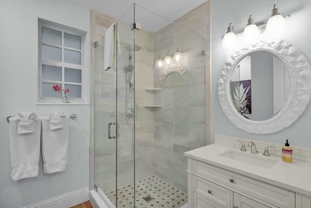 bathroom with a shower stall and vanity