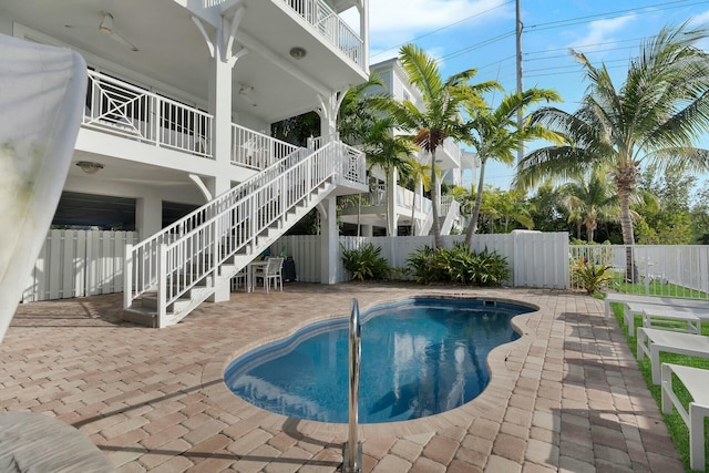 view of swimming pool featuring fence private yard, a patio area, stairs, and a fenced in pool